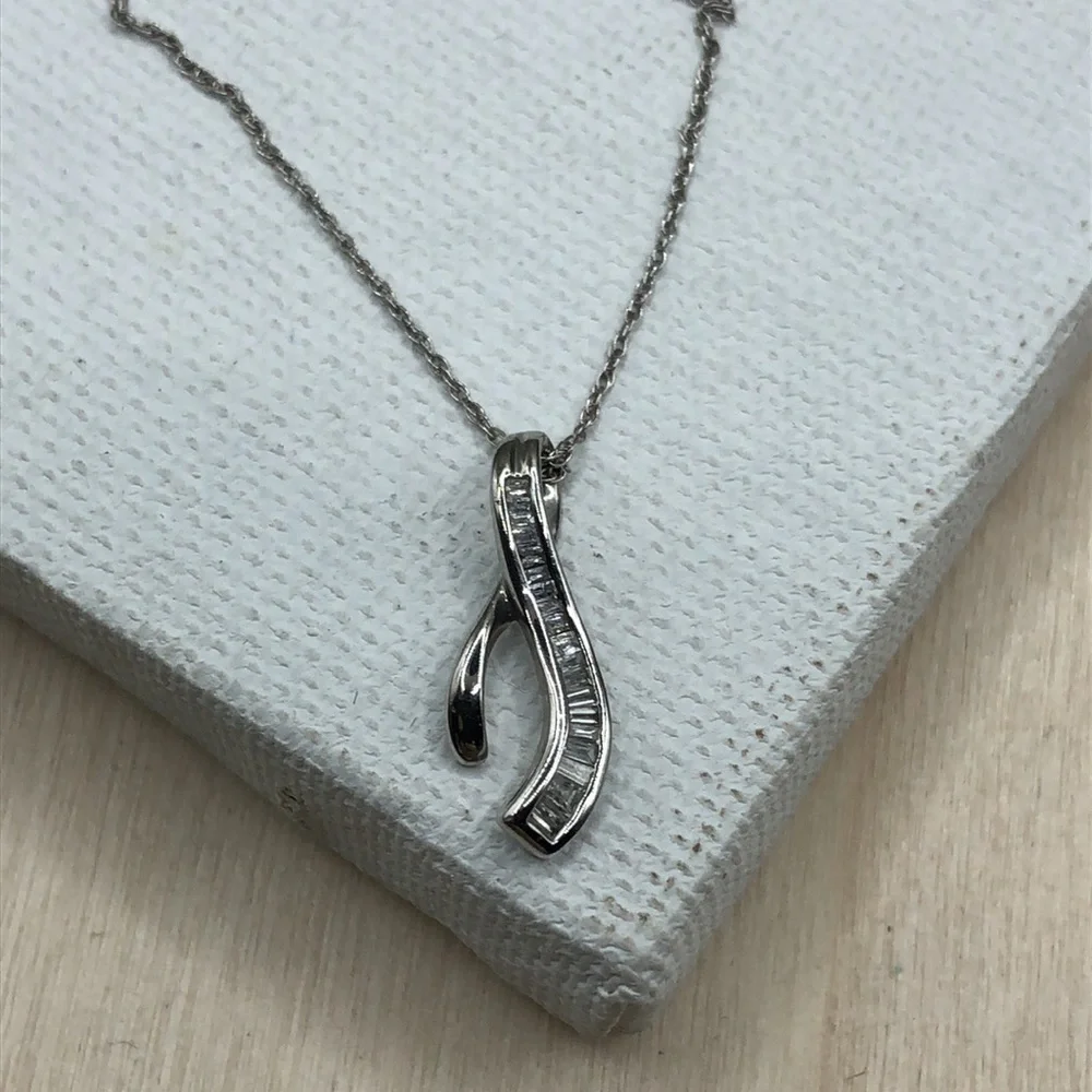 Solid 10k white gold multi baguette diamond wishbone pendant necklace.
